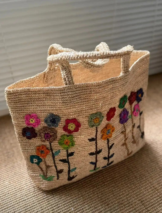 Artisan crochet raffia tote with floral embroidery – natural fiber handbag front view