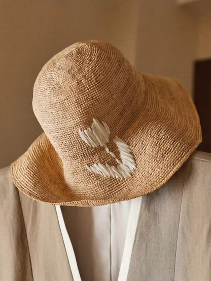 Handwoven natural raffia sun hat with white tulip embroidery and wide brim, artisan summer vacation hat