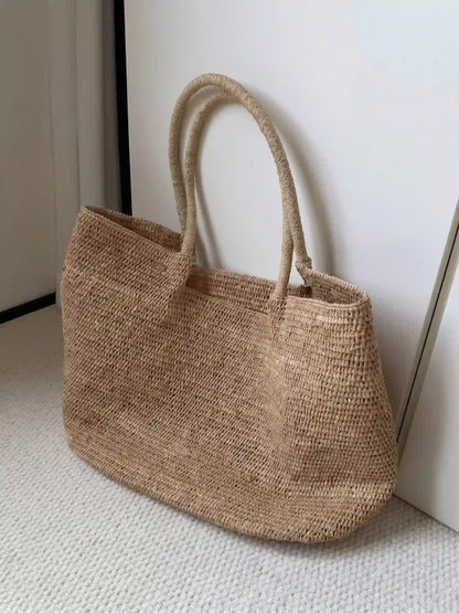 Oversized handwoven natural fiber tote bag with structured silhouette and artisan crochet texture