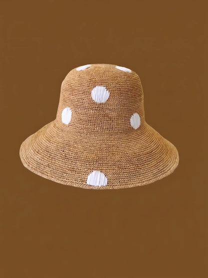 Handwoven raffia hat flat lay – sustainable natural fiber sun hat boho chic styling