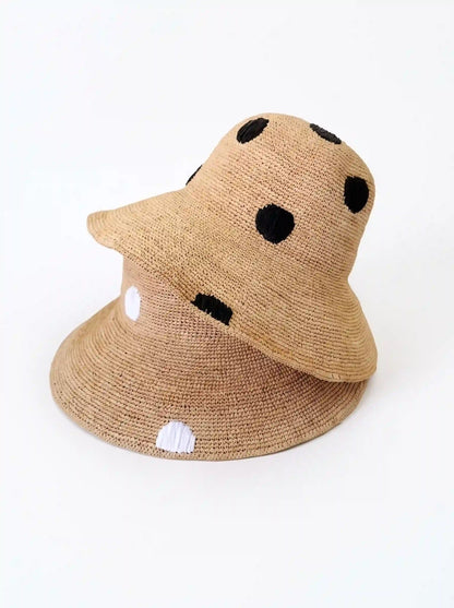 Wide brim raffia sun hat side view – polka dot ribbon trim – quiet luxury summer style
